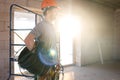 A worker at a construction site holds an electrical cable Royalty Free Stock Photo