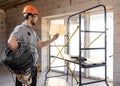 A worker at a construction site holds an electrical cable Royalty Free Stock Photo