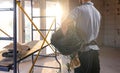 A worker at a construction site holds an electrical cable Royalty Free Stock Photo