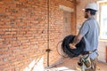 A worker at a construction site holds an electrical cable Royalty Free Stock Photo