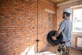 A worker at a construction site holds an electrical cable Royalty Free Stock Photo