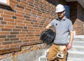 A worker at a construction site holds an electrical cable Royalty Free Stock Photo