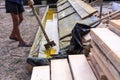 Worker at a construction site at home covers antiseptic boards. Impregnation of boards