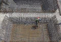 Worker in the construction site making reinforcement metal framework for concrete pouring