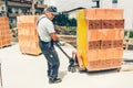 Worker on construction site, moving bricks and working on building walls Royalty Free Stock Photo