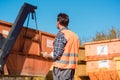 Worker on construction site unloading container for waste from t Royalty Free Stock Photo