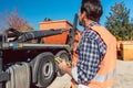 Worker on construction site unloading container for waste from truck Royalty Free Stock Photo
