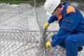 Worker on a construction site in a white helmet makes the construction of iron wire, top view, close-up Royalty Free Stock Photo