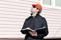 Worker on a construction site in winter looks at the drawing Royalty Free Stock Photo