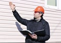 Worker on a construction site in winter looks at the drawing Royalty Free Stock Photo