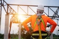 A Worker in construction site Working at height equipment. Fall arrestor device for worker with hooks for safety body harness Royalty Free Stock Photo