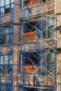 Worker at a construction site are working on a scaffold at an old typical new york brick building