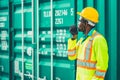 Worker control loading containers cargo at port shipyard with green color container box for eco logistic industry image concept