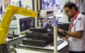Worker control robot arm to loading and unloading workpiece