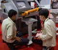 Worker control robot arm to loading and unloading workpiece