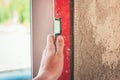 Worker control wall near window using level tool Royalty Free Stock Photo