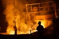 Worker controlling metal melting in furnaces