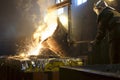 Worker controlling metal melting in furnaces. Worker operates at the metallurgical plant. The liquid metal is poured