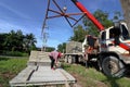 Worker controls of lifting crane for transporting concrete slabs