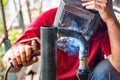 Worker cooks the heating pipe, welding joint. Preparing for winter heating Royalty Free Stock Photo