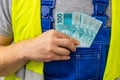 Worker counting his earnings, Brazilian money, Concept of wages and labor costs in industry Royalty Free Stock Photo