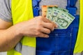 Worker counting his earnings, Costa Rica money, Concept of wages and labor costs in industry