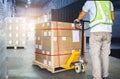 Worker Courier Unloading Package Boxes in Distribution Warehouse Center. Shipments Supply Chain Delivery service. Truck Loading Royalty Free Stock Photo