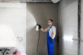 Worker covering automobile with foam at car wash.