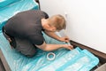 Worker covering stairs carpet with masking film