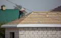 Worker covers the roof of the house Royalty Free Stock Photo