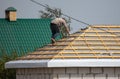 Worker covers the roof of the house Royalty Free Stock Photo