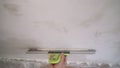 The worker processes the wall with putty. Hand with putty knife repair wall, Hand with a spatula, spatula with spackle paste Royalty Free Stock Photo