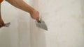 The worker processes the wall with putty. Hand with putty knife repair wall, Hand with a spatula, spatula with spackle paste Royalty Free Stock Photo
