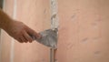 Plasterer putting plaster on wall. Worker covers the wall with mortar