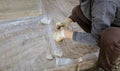 A worker creates a form for pouring concrete