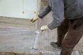 A worker creates a form for pouring concrete