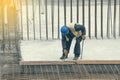 Worker with crowbar removing wooden formworks 2