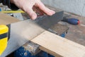A worker cut a plank of wood Royalty Free Stock Photo