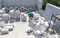 A worker cuts aerated concrete bricks with a saw