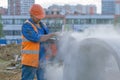 Worker cuts the concrete ring at the construction site