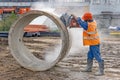 Worker cuts the concrete ring