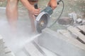 A worker cuts concrete slabs. Royalty Free Stock Photo