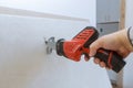 Worker cuts with a dirty saw drywall cutting gypsum board