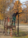 Worker cuts dry branches from a tree