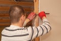 A worker cuts drywall at a construction site