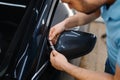 Worker cuts film, car tinting installation process Royalty Free Stock Photo