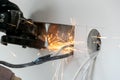 Worker cuts a hole in the wall. Installing new outlets. Work with an electric tool or angle drive grinder. dangerous job. Royalty Free Stock Photo