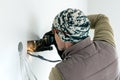 Worker cuts a hole in the wall. Installing new outlets. Work with an electric tool or angle drive grinder. dangerous job. Royalty Free Stock Photo