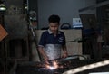 A worker cuts iron plates