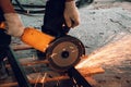 Worker Cuts Metal with Grinder Circular Blade on Construction Site, close up